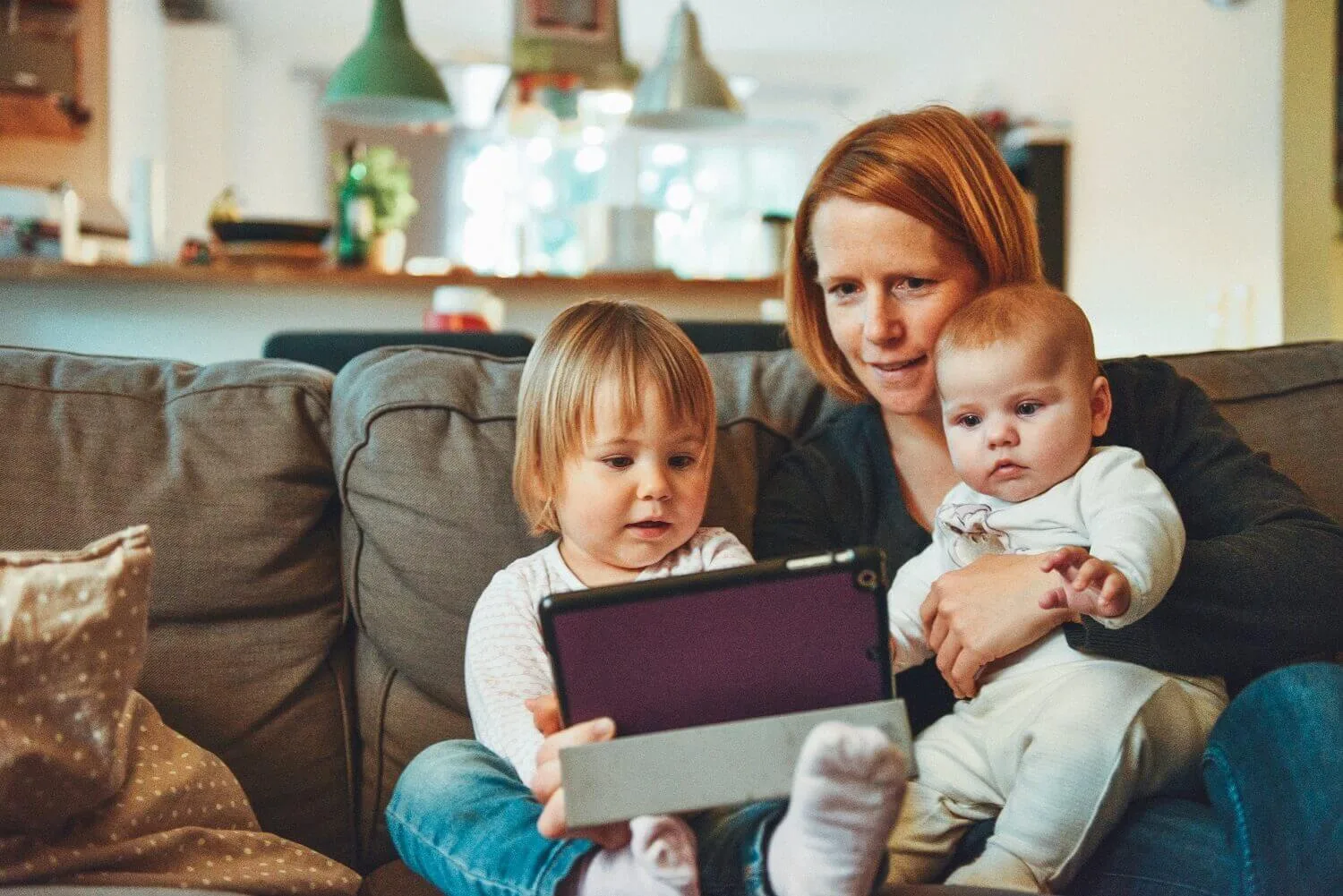 Mother and children watching virtual memorial service
