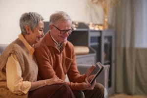 Elderly couple watching virtual memorial service