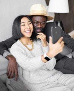 Younger couple joining virtual memorial service or an virtual funeral service.